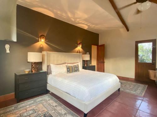 a bedroom with a white bed and a black wall at Home With Private Pool Ocean and Mountain Views in Los Barriles
