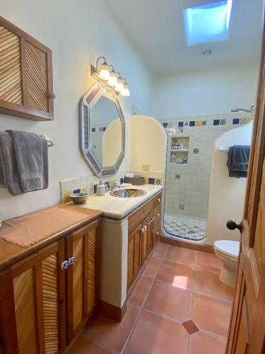 a bathroom with a sink and a toilet and a mirror at Home With Private Pool Ocean and Mountain Views in Los Barriles