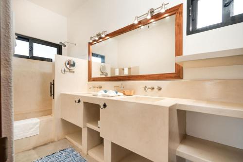 a bathroom with a sink and a mirror at Montebello Pool House-3 BD in Los Barriles