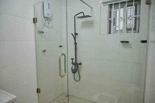 a shower with a glass door in a bathroom at Eljay Luxury Stay in Ashalebotwe