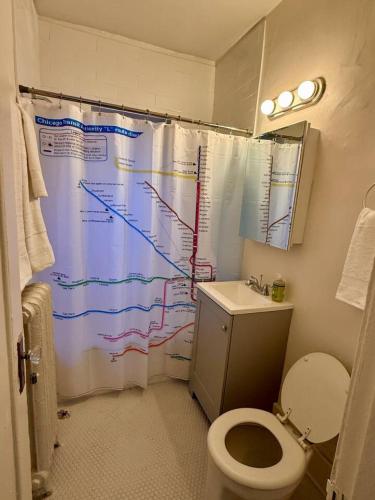 a bathroom with a shower curtain with a map on it at Well Located Studio on the Red Line in Chicago