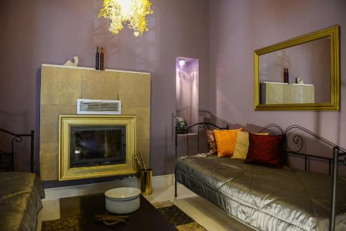 a living room with a couch and a fireplace at Maison de la Poupée in Afétai