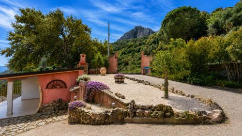 a house with a garden in front of a mountain at TacchiHousePanorama in Jerzu