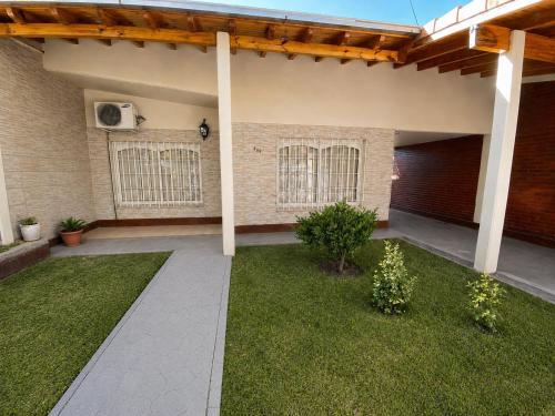 a patio of a house with a grass yard at Casa TiaMaria - Centro San Rafael in San Rafael