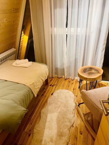 a room with two beds and a table and a window at Villa Antonela Kupres in Kupres