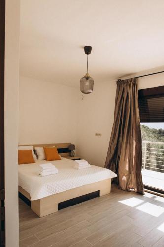 a bedroom with a bed in front of a window at Carob Breeze House in Krimovice