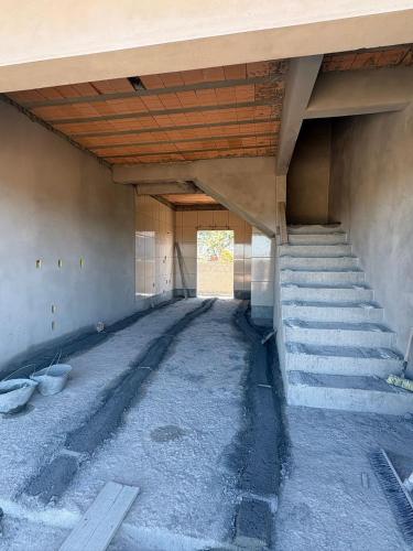 an empty room with stairs in a building at Costa Atlântico House in Garopaba