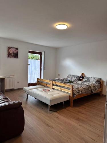 a large room with two beds and a window at Traumhaus in Küssaberg