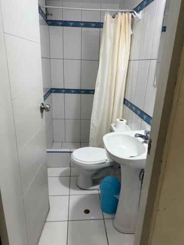 a bathroom with a toilet and a sink at HOTEL SANTA BARBARA PUERTO ilo in Ilo