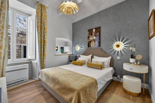 a bedroom with a large bed and a window at Dominus Little Palace in Dubrovnik