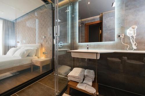 a bathroom with a shower and a sink at Chic Boutique Hotel Vlore in Vlorë