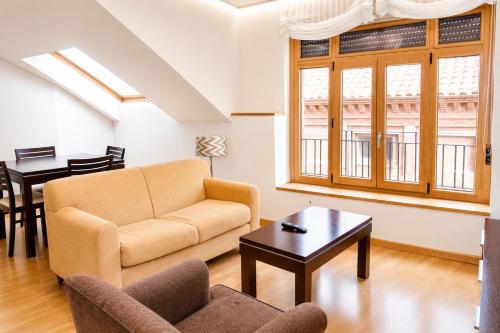 a living room with a couch and a table at Apartamentos 19 Living in León