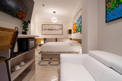 a hotel room with a bed and a couch at DibraLuxurySuites Duomo in Milan