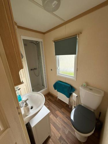 a small bathroom with a toilet and a sink at Melrose in Lancaster