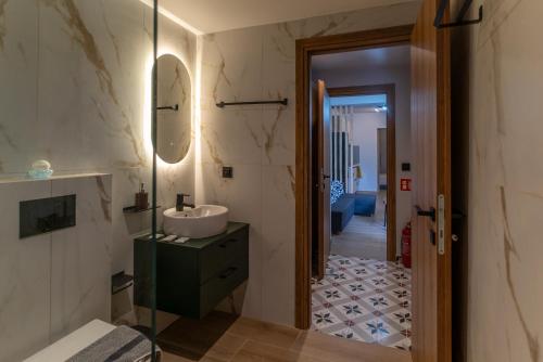 a bathroom with a sink and a mirror at Latitude 37 Luxe in Kalamata