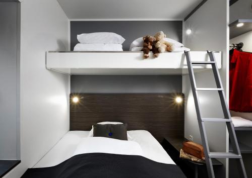 a bedroom with two bunk beds with two teddy bears at Cabinn Aarhus in Aarhus