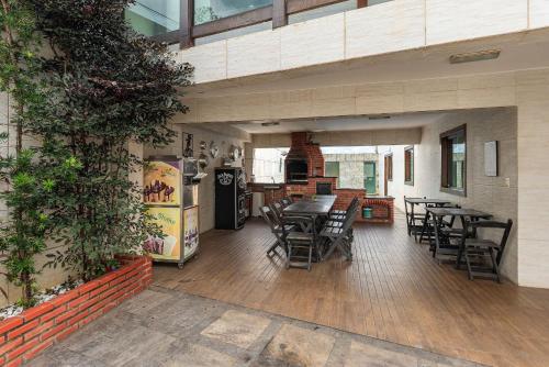 a kitchen and dining room with tables and chairs at House with Pool in BH for Groups and Families in Belo Horizonte