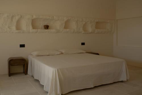 a bedroom with a bed with a white bedspread at Casa Olivi in Ventotene
