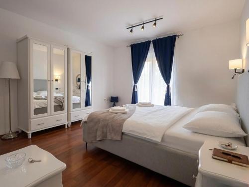 a bedroom with a large bed and a large window at Moro Crikva in Crikvenica
