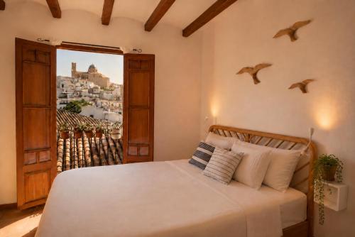 a bedroom with a bed with birds on the wall at Casa en Bellaguarda by NRAS in Altea