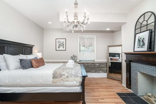 a bedroom with a large bed and a fireplace at Rutledge After Dark - Walk to Broadway & The Gulch in Nashville