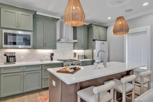a kitchen with green cabinets and a white counter top at Resonant - 2 Townhomes - 2 Private Rooftop Decks in Nashville