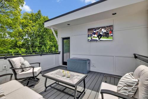 a screened in porch with a table and chairs at Resonant - 2 Townhomes - 2 Private Rooftop Decks in Nashville