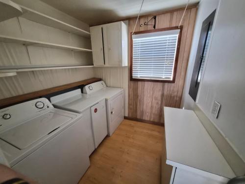 a small laundry room with a washer and dryer at Sand Spur Cottages in Nags Head