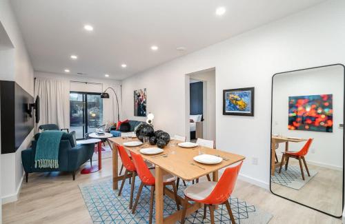 a dining room and living room with a table and chairs at Hyve-Retro Modern-Full Gym-Walk to Broadway in Nashville