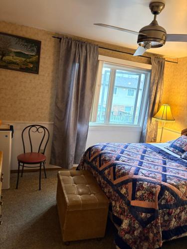 a bedroom with a bed and a window and a chair at Comfortable stay in Milton