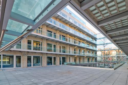 an external view of a building with large windows at Hotel Mosaic City Centre in Amsterdam