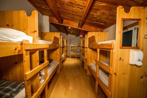a room with several bunk beds in a cabin at HI Kananaskis Wilderness - Hostel in Kananaskis Village