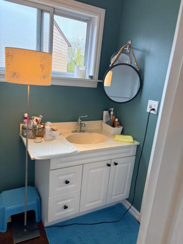 a bathroom with a sink and a mirror at Comfortable stay in Milton