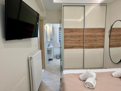 a bedroom with a flat screen tv on the wall at Little Spyrela in Sinarádes
