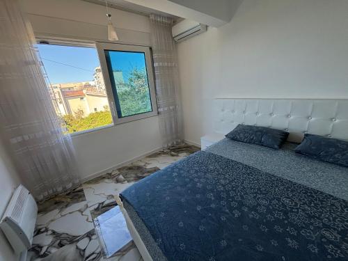 a bedroom with a large bed and a window at Villa Diel 300m vom Strand in Utjeha