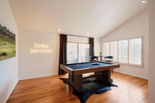 a living room with a pool table in it at Cactus Spur - Pool & Fire Pit - Mins to Old Town in Scottsdale