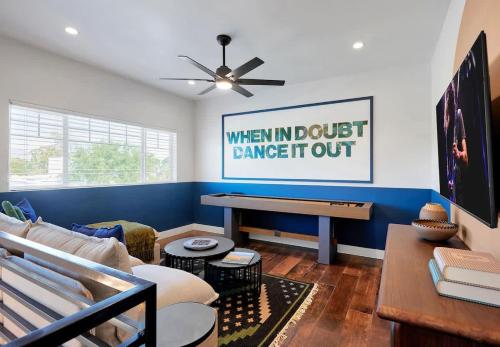 a living room with a couch and a piano at Contour - Sparkling Pool - Mins to Phoenician Golf in Phoenix
