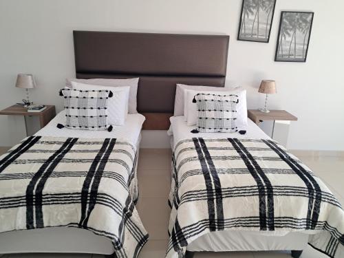 two beds sitting next to each other in a bedroom at JUSTSAND Guesthouse in Virginia