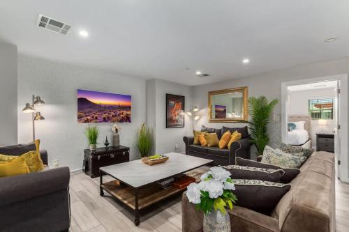 a living room with a couch and a table at Pristine Sunset- In Old Town - Private Pool - BBQ in Scottsdale