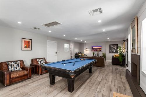a living room with a pool table in it at Pristine Sunset- In Old Town - Private Pool - BBQ in Scottsdale