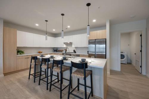 a kitchen with a large island with bar stools at Hyve - Mahogany - Walk to Broadway in Nashville