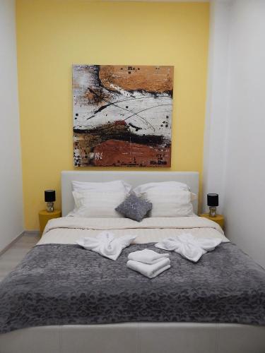 a bedroom with a bed with towels on it at BudapestEasyFlat Basilica Lux in Budapest