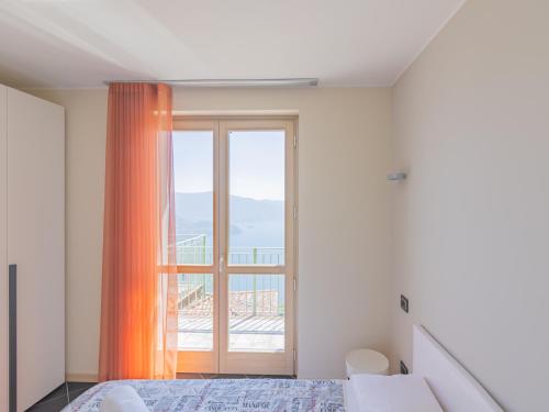 a bedroom with a bed and a large window at EnjoyIseoLake - Modigliani in Parzanica