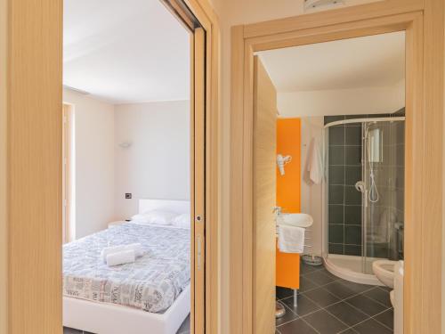 a bedroom with a bed and a bathroom with a shower at EnjoyIseoLake - Modigliani in Parzanica
