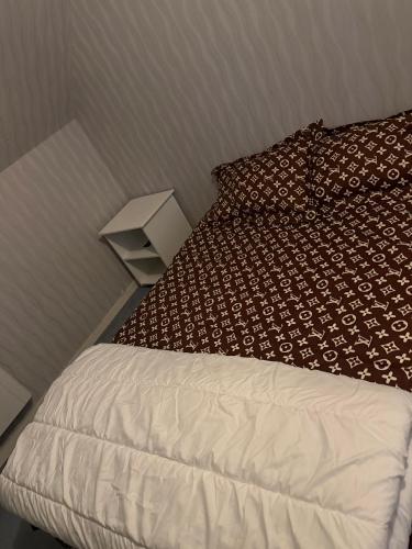 a bedroom with a bed with a pillow and a lamp at Orléans passe in Olivet