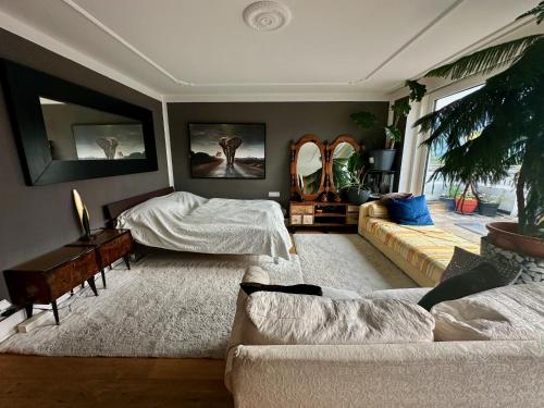 a living room with a bed and a couch at Penthouse in Schaan in Schaan