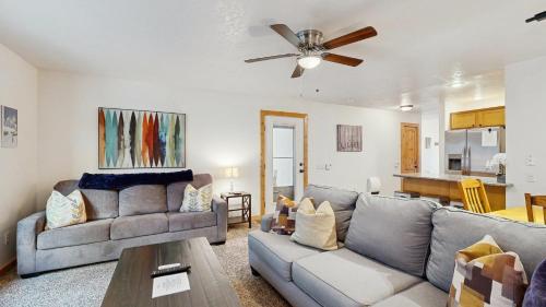 a living room with a couch and a ceiling fan at Payette Pines Hideaway in McCall