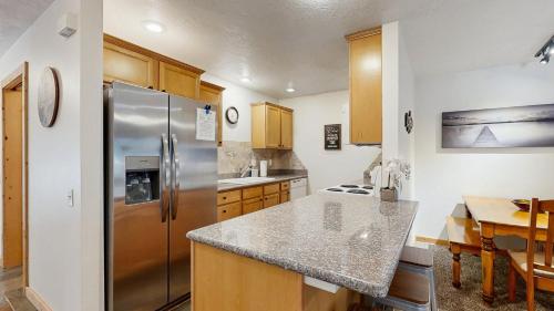 a kitchen with a stainless steel refrigerator and a table at Payette Pines Hideaway in McCall