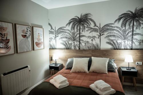 a bedroom with a bed with two towels on it at ALMOHADES del JERTE in Galisteo