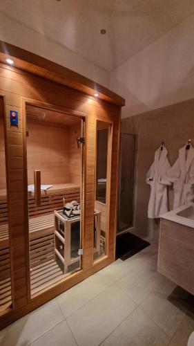 a bathroom with a tub with a sink and a mirror at BudapestEasyFlat Basilica Lux in Budapest